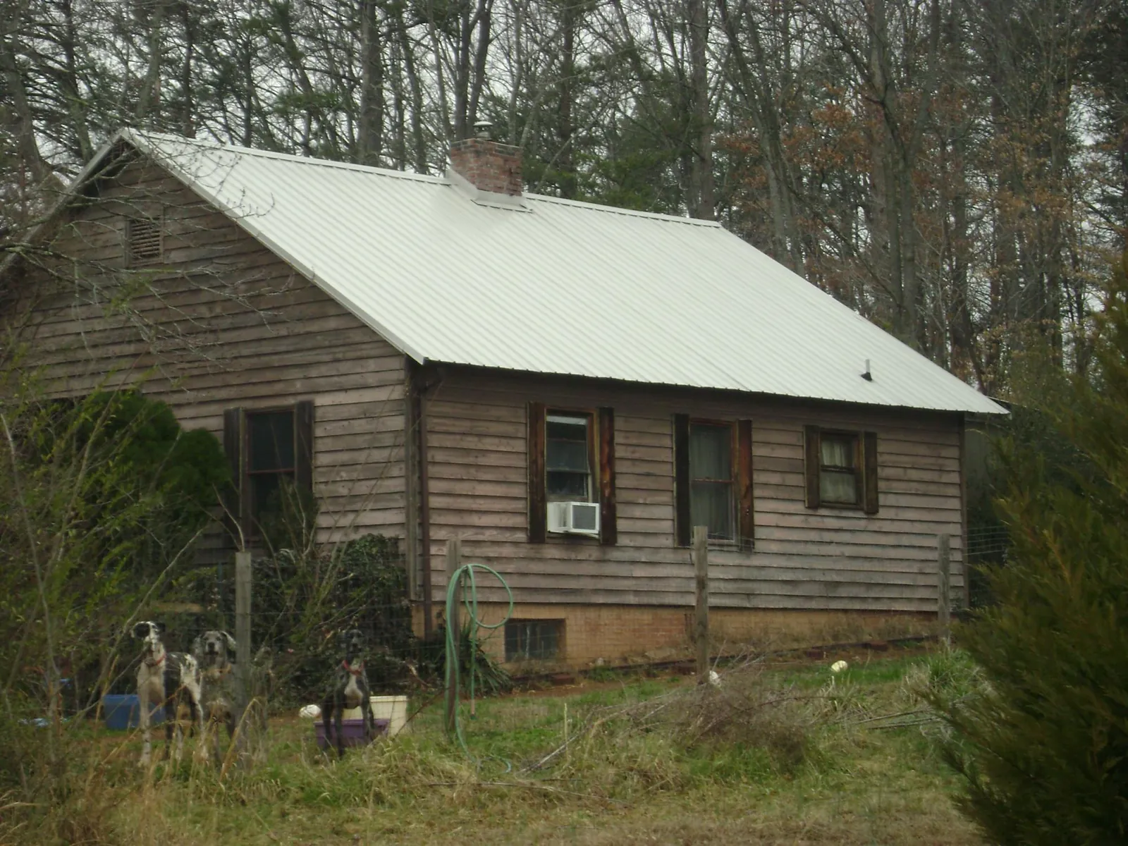 White metal roof on an old wood sided farmhouse, from a Metal Roof Installation job in Fairhaven